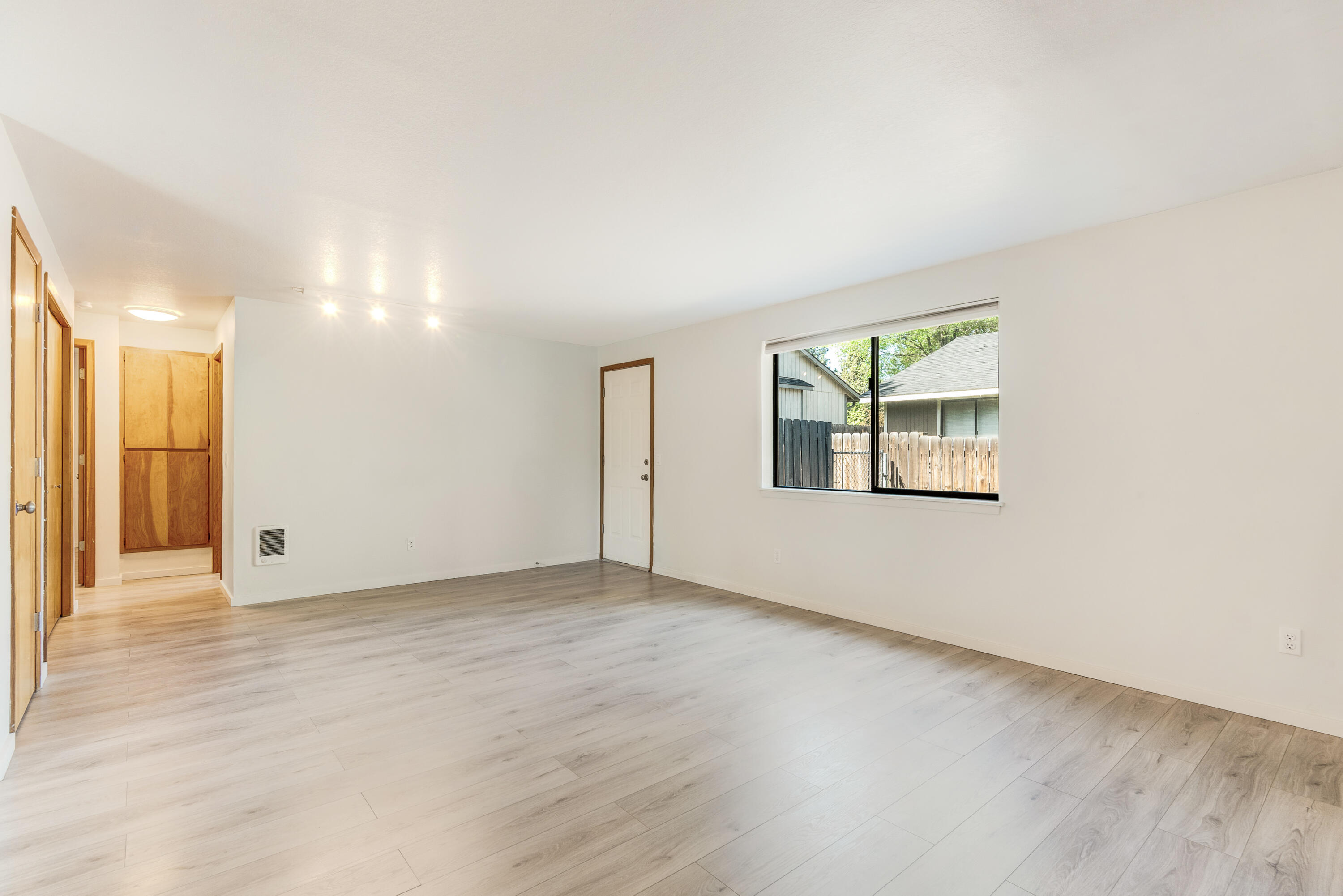 1916 Northeast Wichita Way Bend, OR 97701 - Photo 7 of 38 an empty room with wooden floor and windows