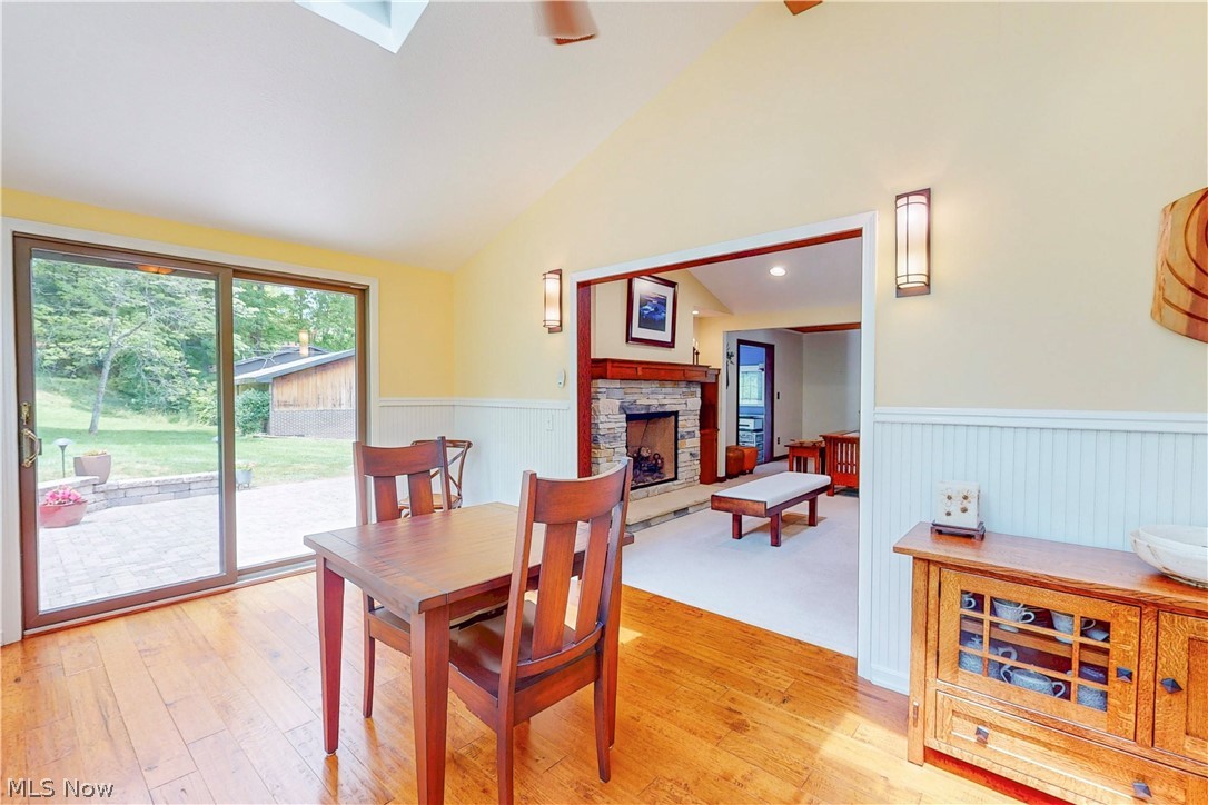 86532 North Bay Road Scio, OH 43988 - Photo 17 of 48 Spacious dining area featuring wood-finish flooring, a vaulted ceiling with a skylight, and white beadboard wainscoting