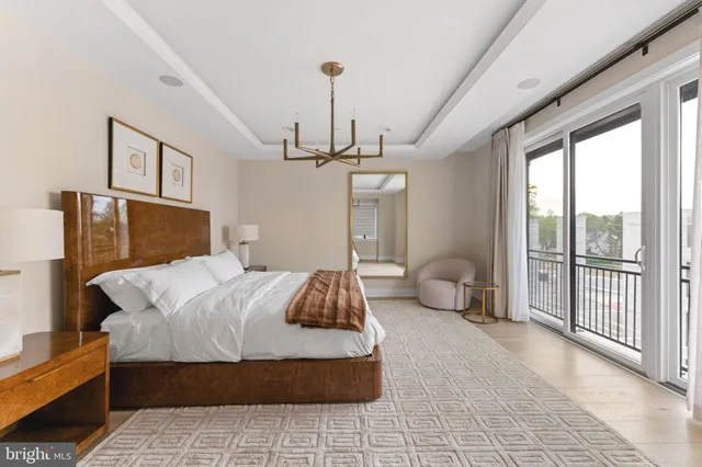 a spacious bathroom with a granite countertop sink a mirror and a bathtub