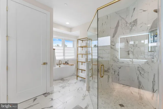 a bathroom with a granite countertop sink a toilet and shower