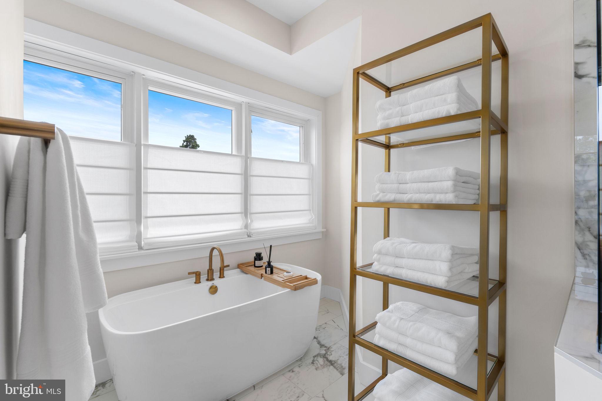 1622 Chain Bridge Road McLean, VA 22101 - Photo 28 of 72 a bathroom with a bathtub and a shower