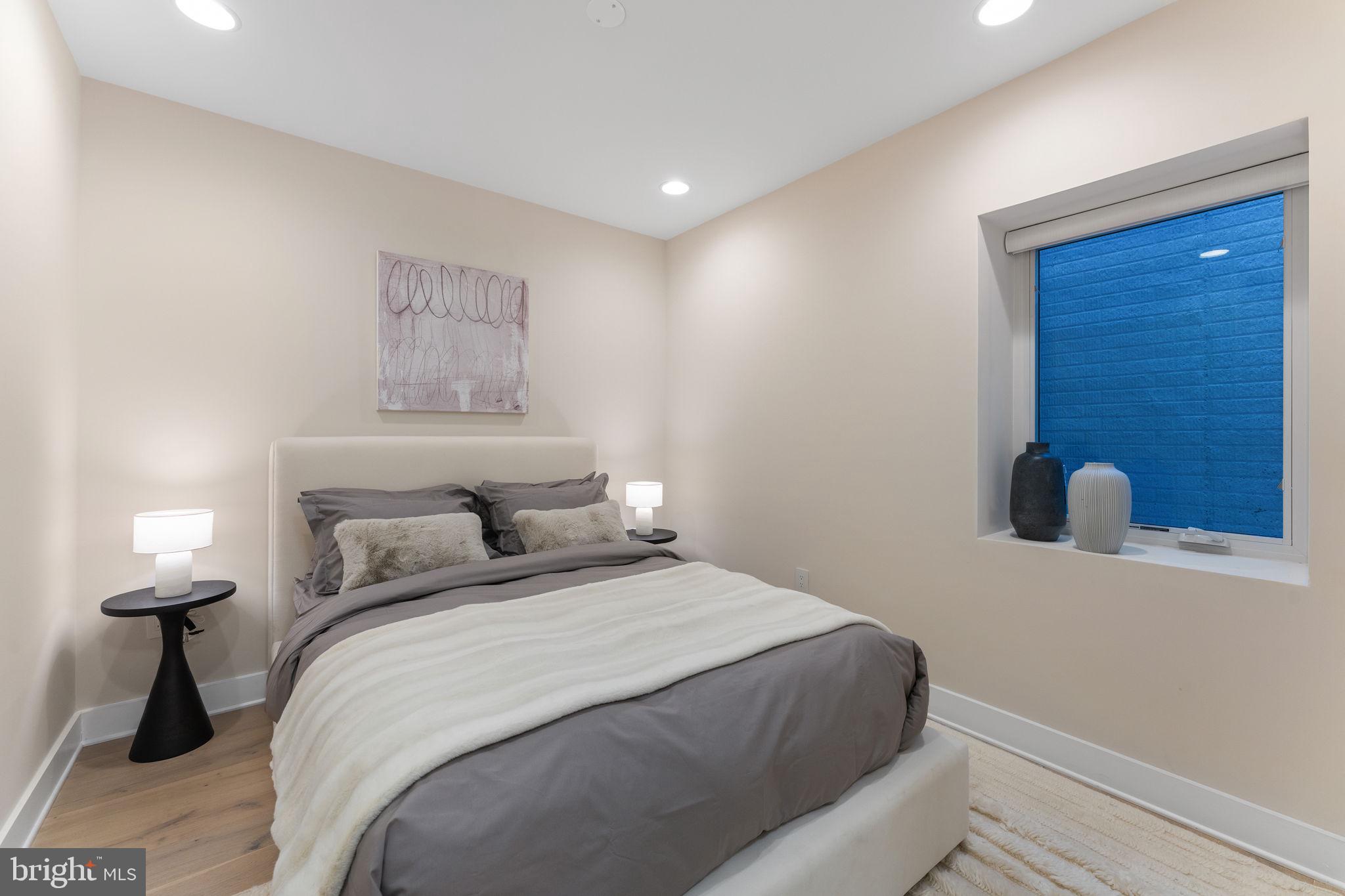 1622 Chain Bridge Road McLean, VA 22101 - Photo 37 of 72 a bedroom with a bed and a lamp