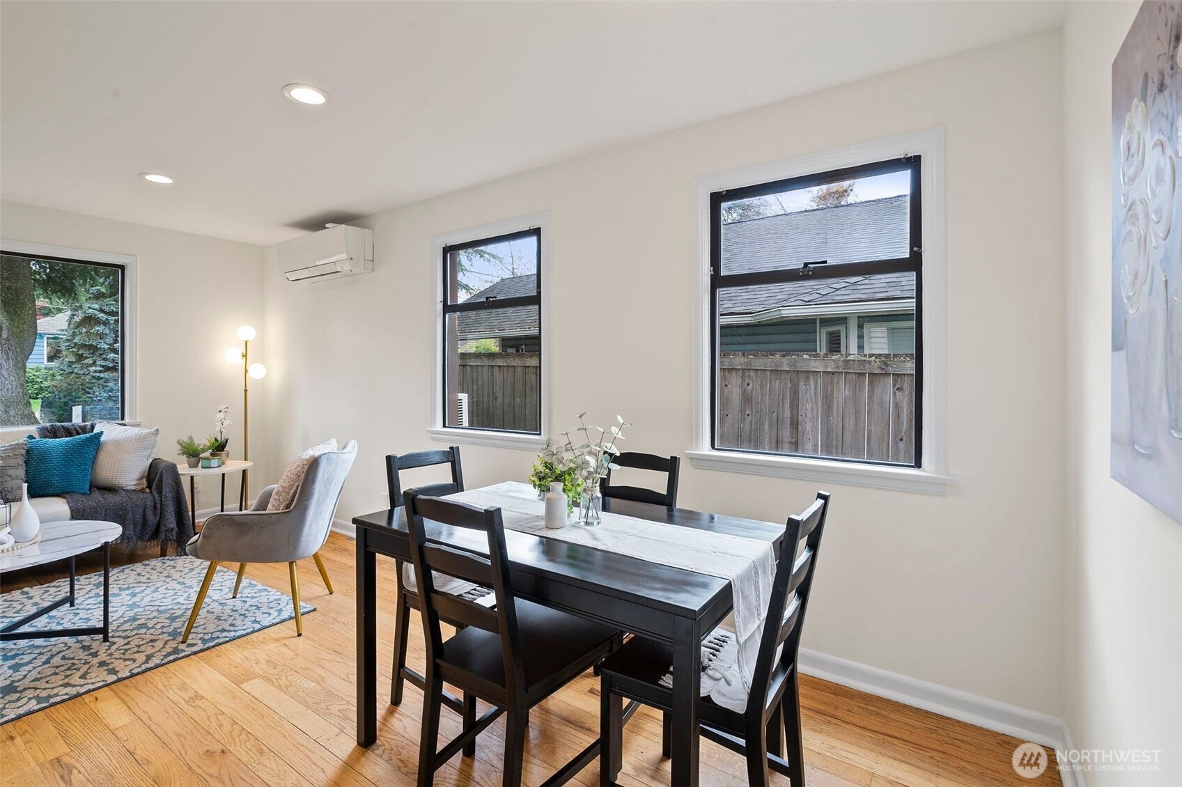 9747 Evanston Avenue North Seattle, WA 98103 - Photo 11 of 34 a view of a dining room with furniture window and wooden floor