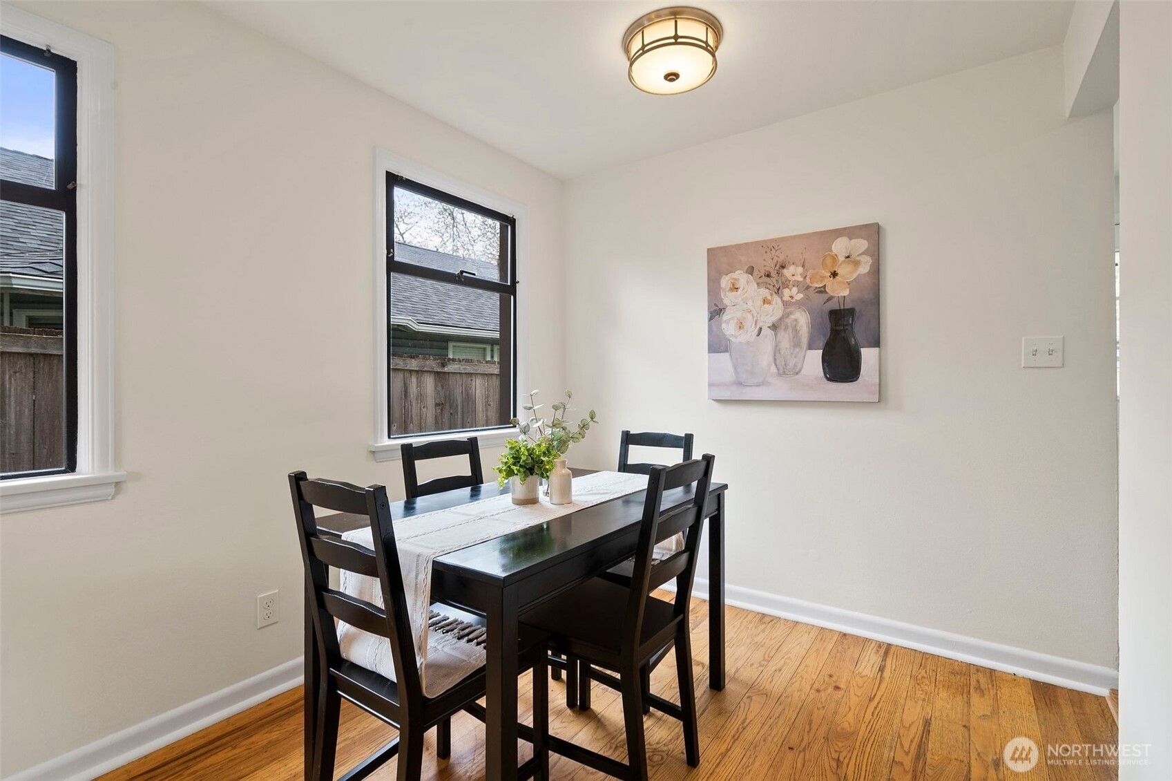 9747 Evanston Avenue North Seattle, WA 98103 - Photo 12 of 34 a view of a dining room with furniture and wooden floor