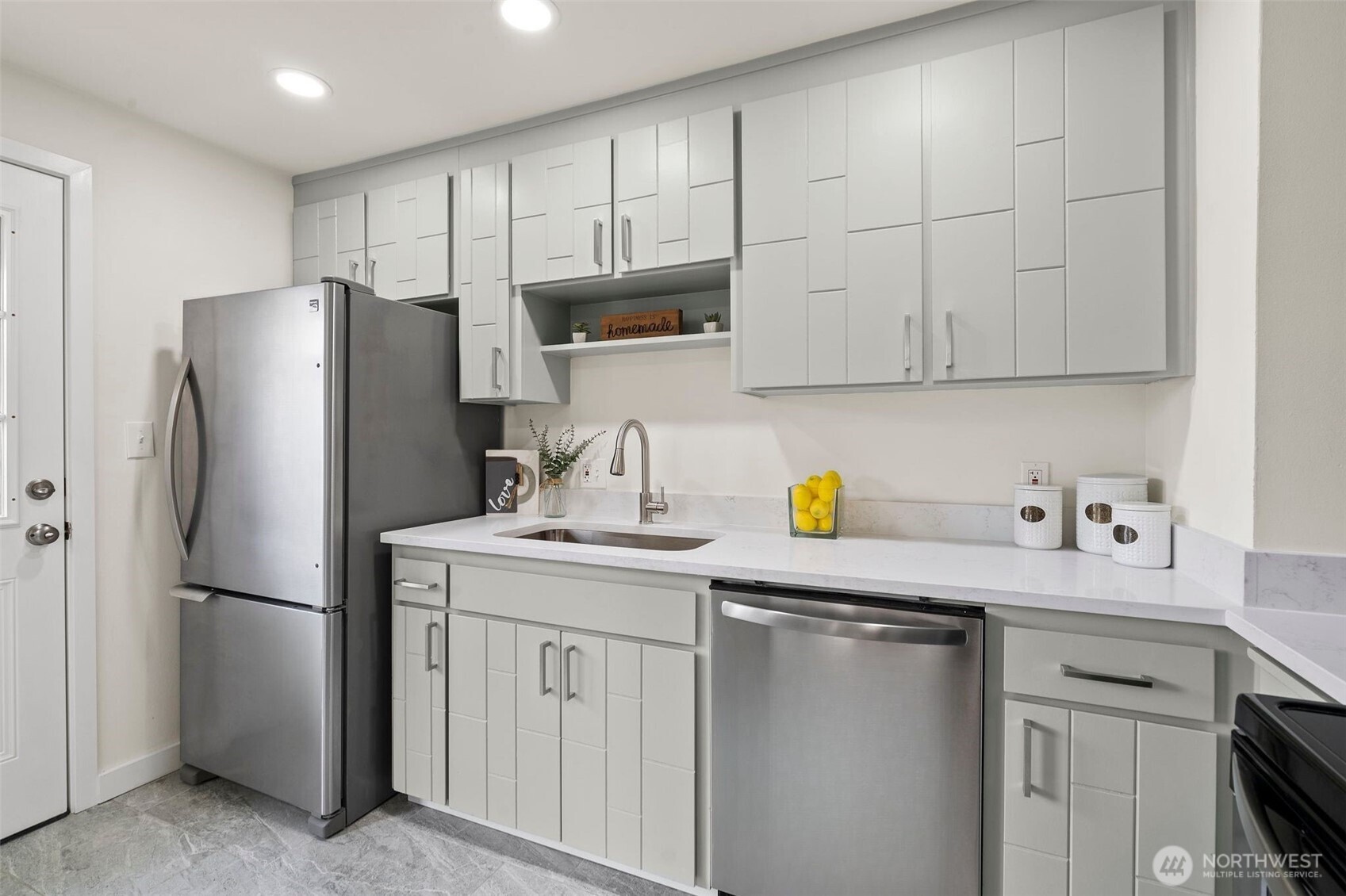 9747 Evanston Avenue North Seattle, WA 98103 - Photo 13 of 34 a kitchen with stainless steel appliances granite countertop a refrigerator sink and cabinets