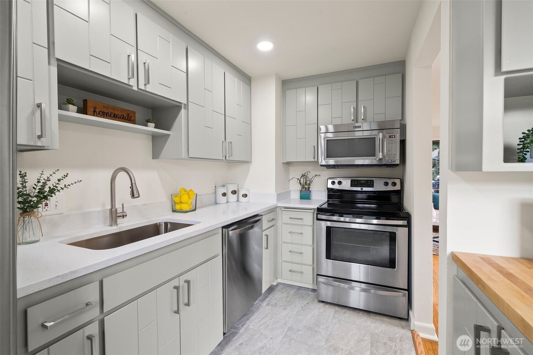 9747 Evanston Avenue North Seattle, WA 98103 - Photo 14 of 34 a kitchen with stainless steel appliances granite countertop a sink stove and refrigerator