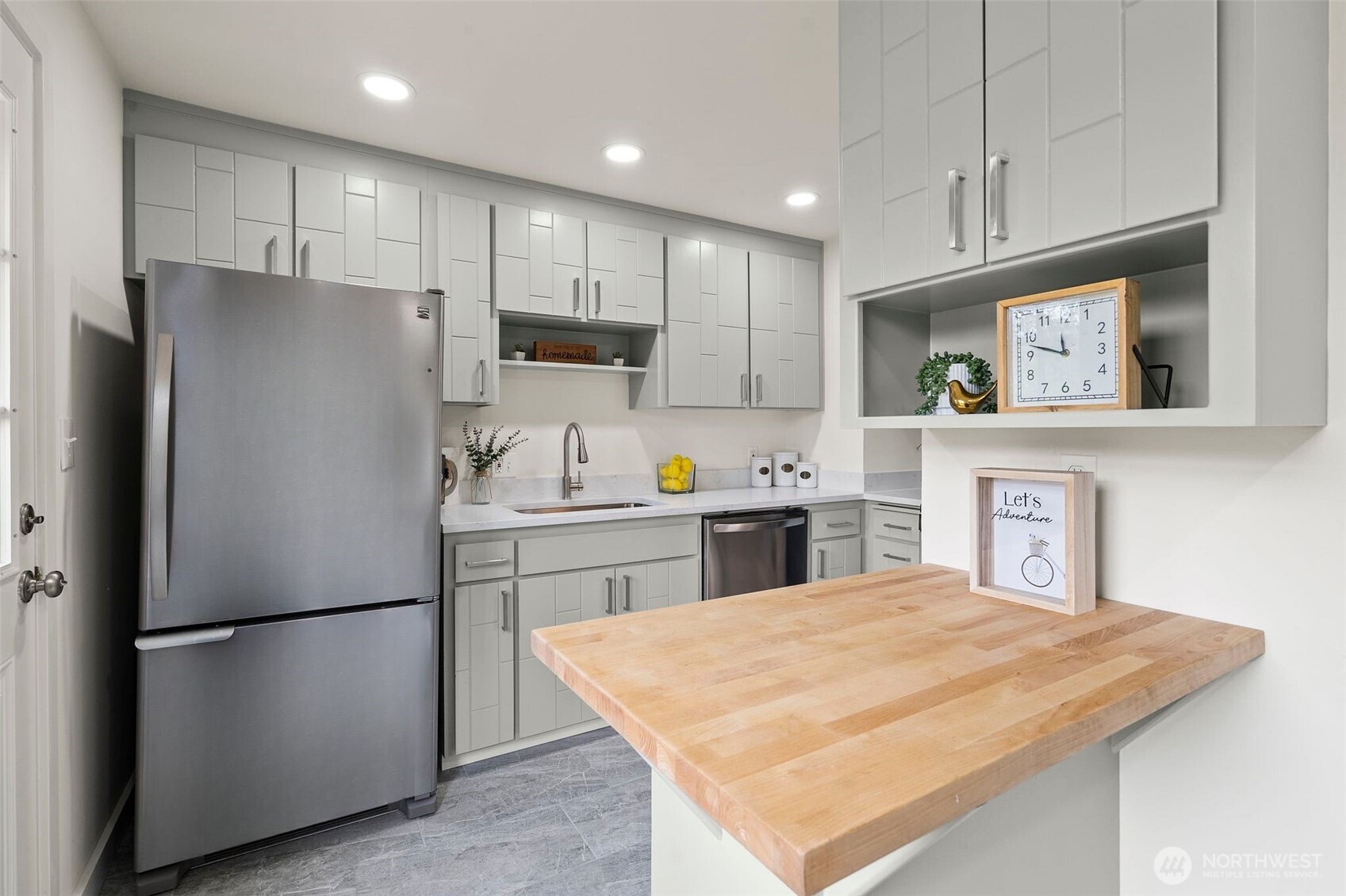 9747 Evanston Avenue North Seattle, WA 98103 - Photo 15 of 34 a kitchen with refrigerator and cabinets