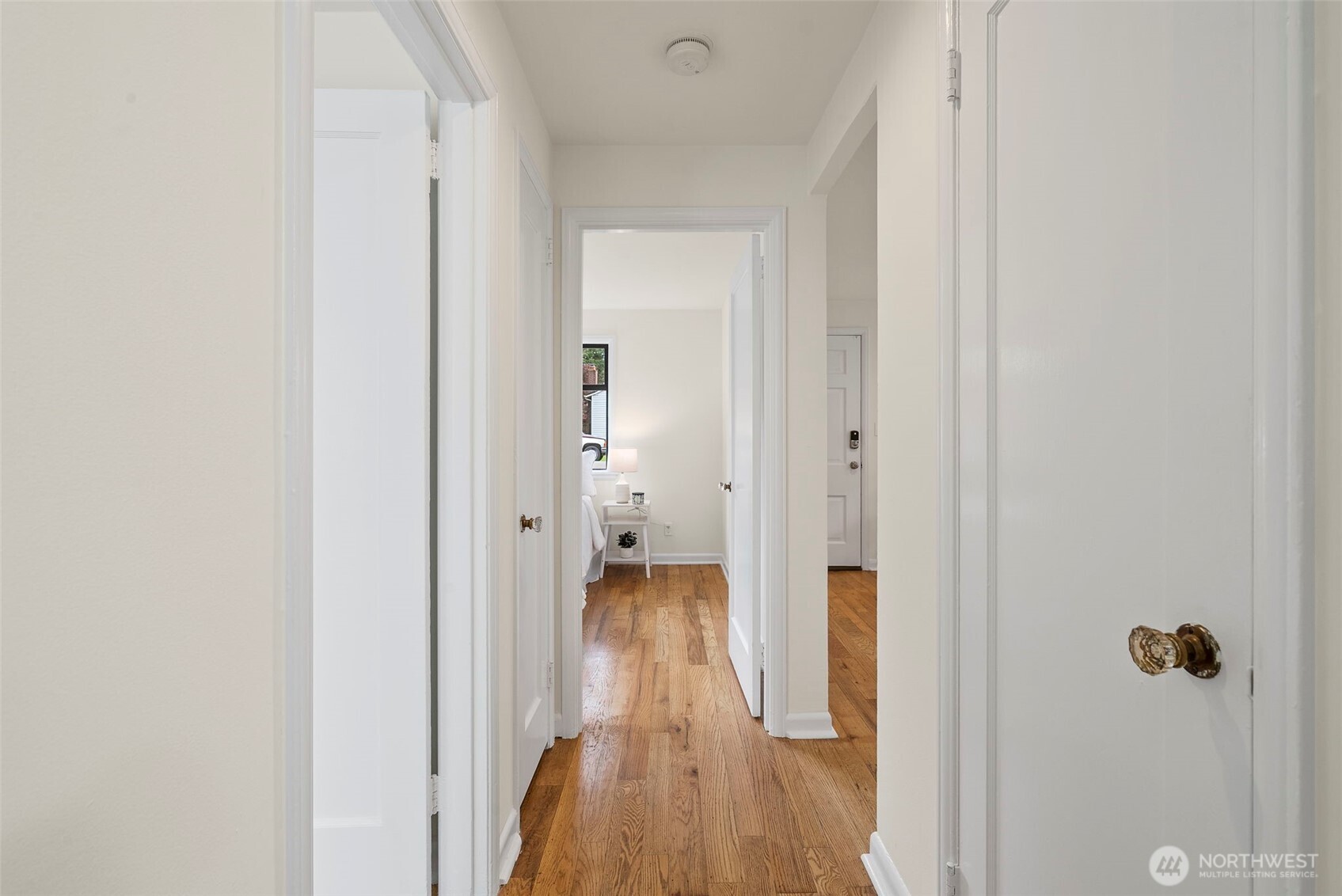 9747 Evanston Avenue North Seattle, WA 98103 - Photo 17 of 34 a view of a hallway with wooden floor and closet area