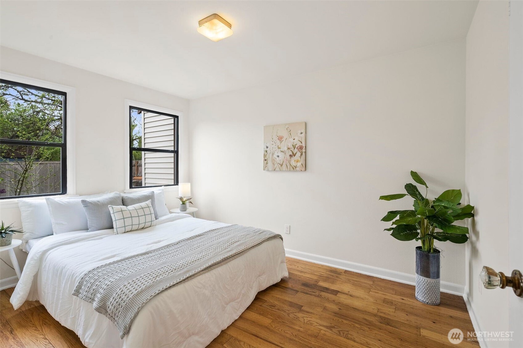 9747 Evanston Avenue North Seattle, WA 98103 - Photo 18 of 34 a bedroom with a bed potted plant and a window