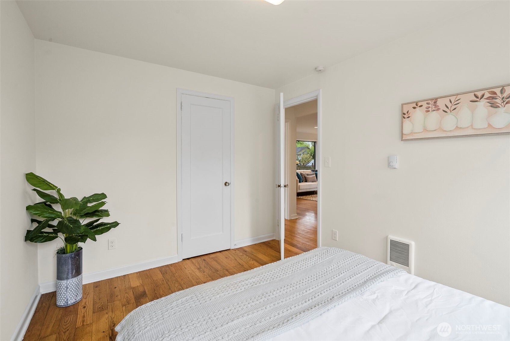 9747 Evanston Avenue North Seattle, WA 98103 - Photo 20 of 34 a bedroom with a bed and a potted plant
