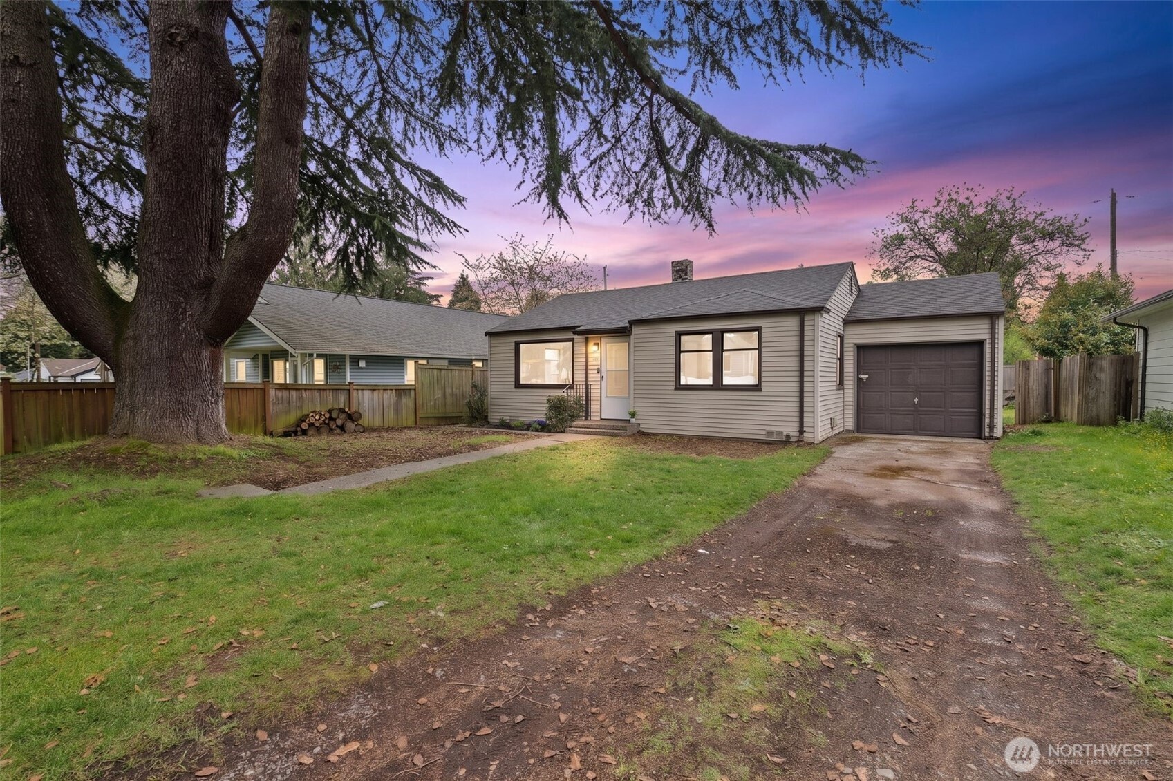 9747 Evanston Avenue North Seattle, WA 98103 - Photo 2 of 34 a front view of a house with yard and green space