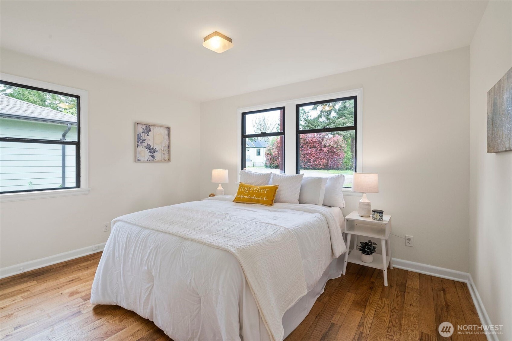 9747 Evanston Avenue North Seattle, WA 98103 - Photo 21 of 34 a bedroom with a bed and wooden floor