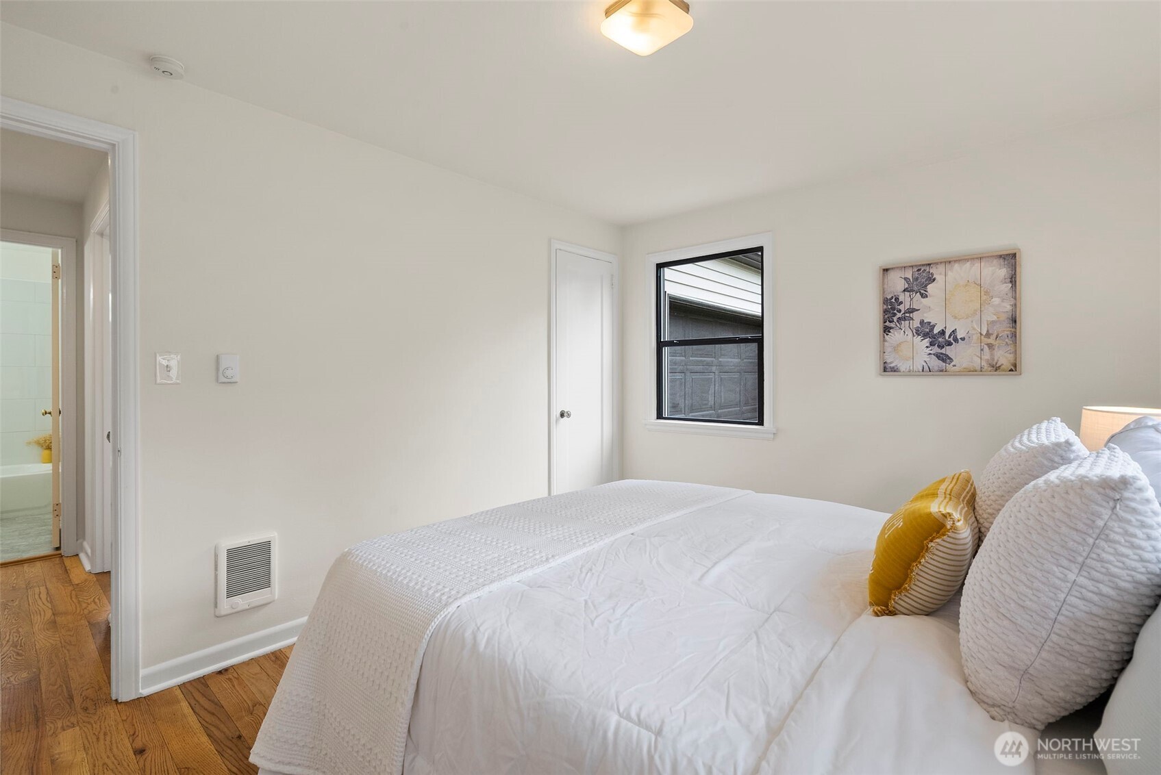 9747 Evanston Avenue North Seattle, WA 98103 - Photo 23 of 34 a bedroom with a bed and a window