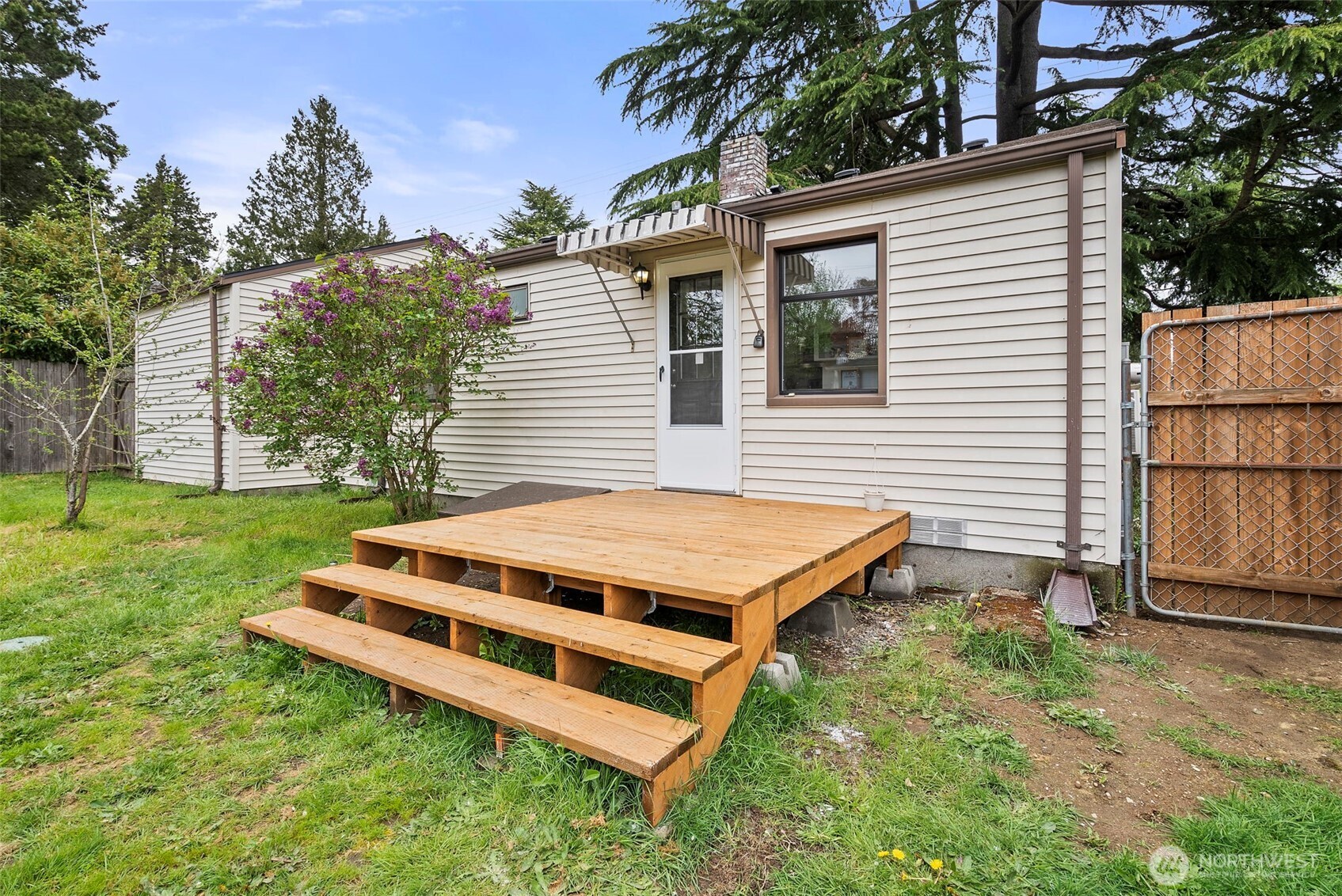 9747 Evanston Avenue North Seattle, WA 98103 - Photo 26 of 34 a backyard of a house with wooden deck and furniture