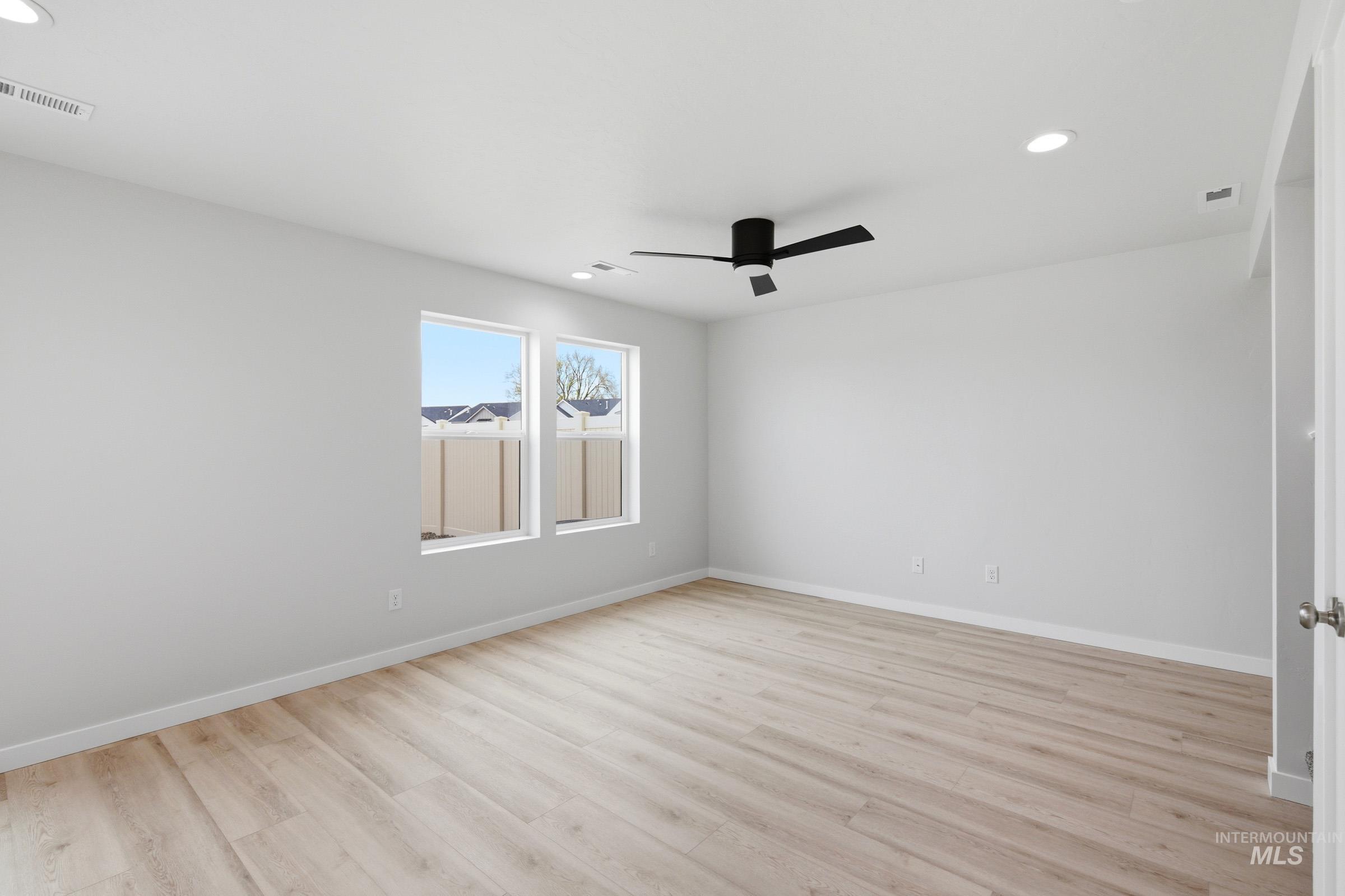 10784 Rutland Street Caldwell, ID 83605 - Photo 11 of 21 Spare room with recessed lighting, light wood-style flooring, and a ceiling fan