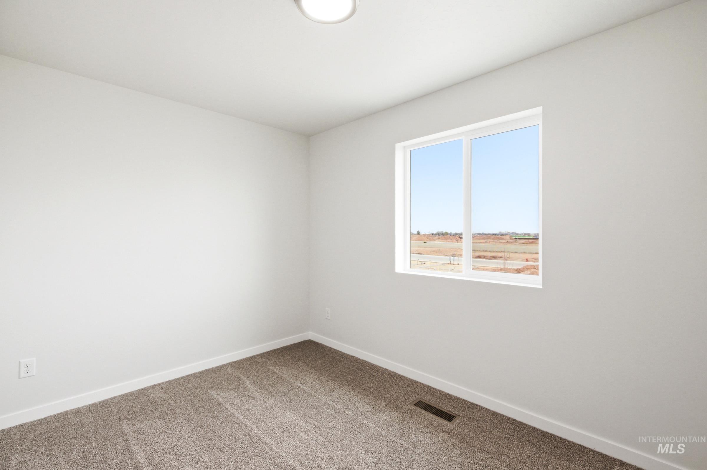 10784 Rutland Street Caldwell, ID 83605 - Photo 13 of 21 Spare room featuring baseboards and carpet floors