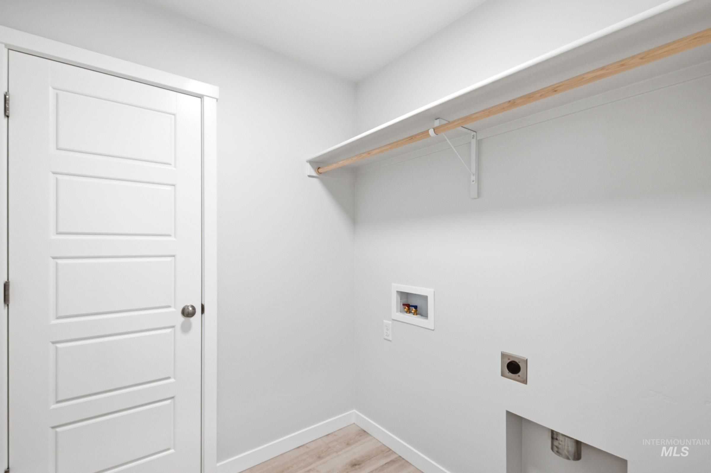 10784 Rutland Street Caldwell, ID 83605 - Photo 15 of 21 Laundry room featuring light wood-type flooring, washer hookup, and electric dryer hookup
