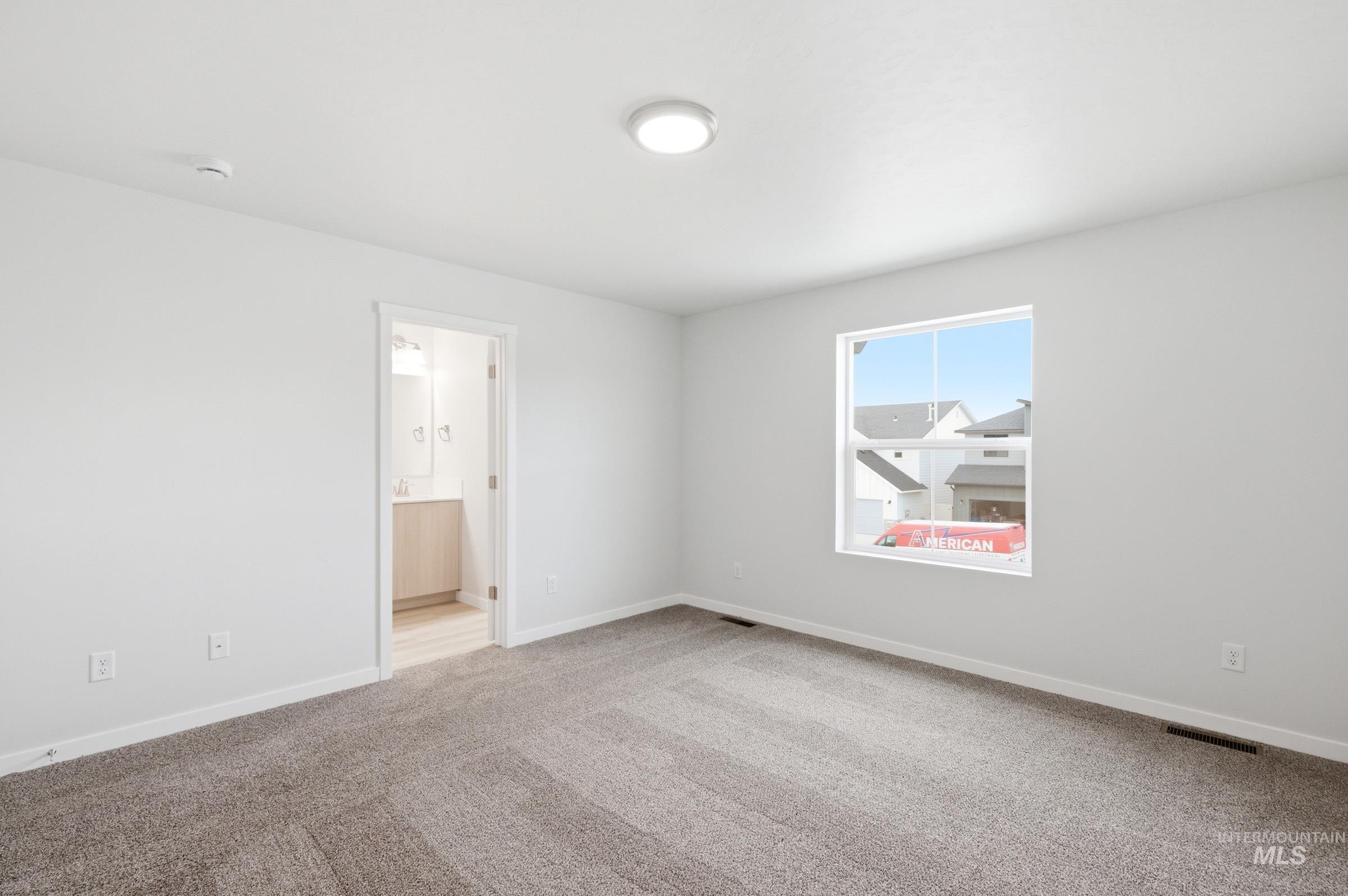 10784 Rutland Street Caldwell, ID 83605 - Photo 16 of 21 Unfurnished room with light carpet and baseboards