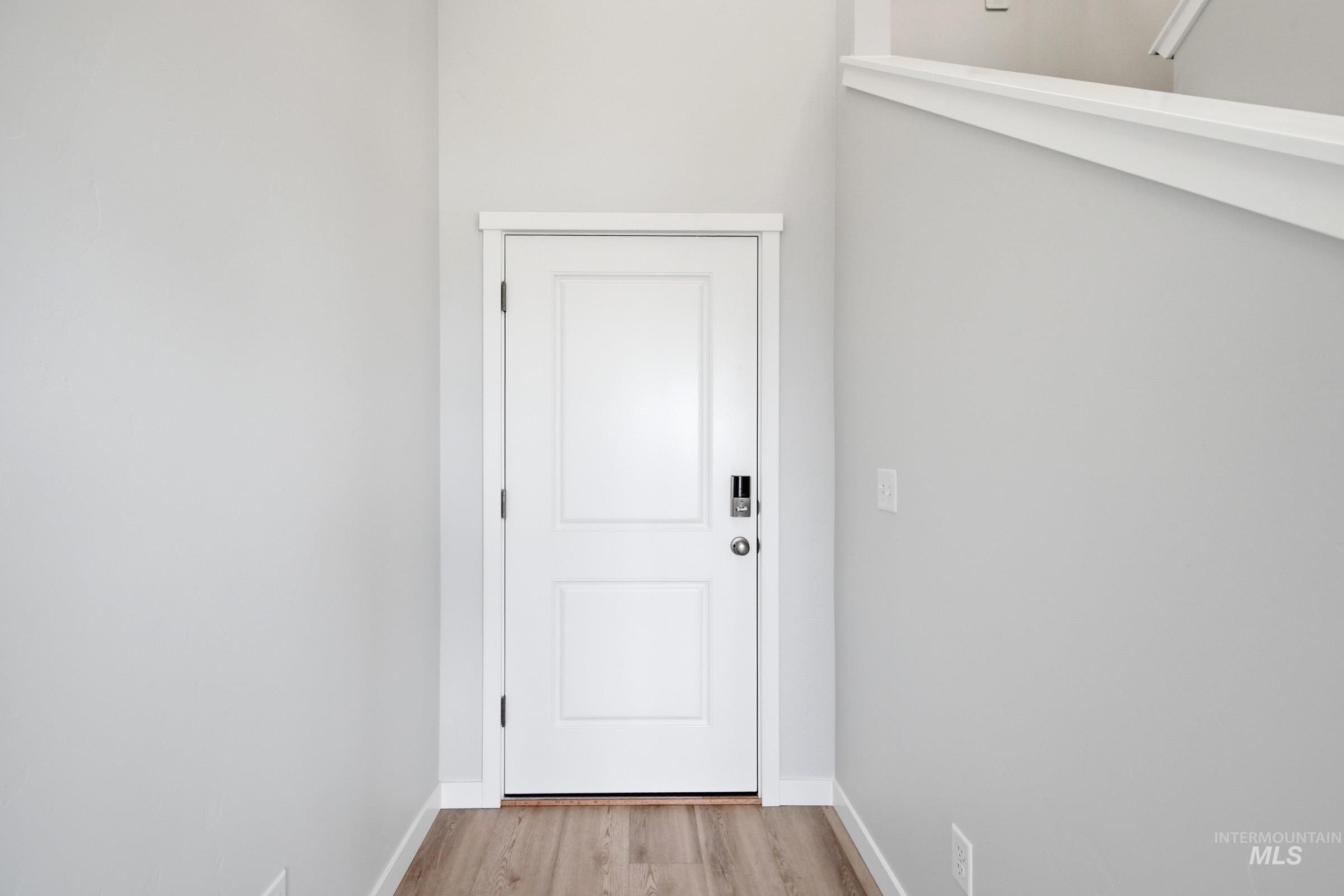 10784 Rutland Street Caldwell, ID 83605 - Photo 2 of 21 Doorway featuring wood finished floors and baseboards