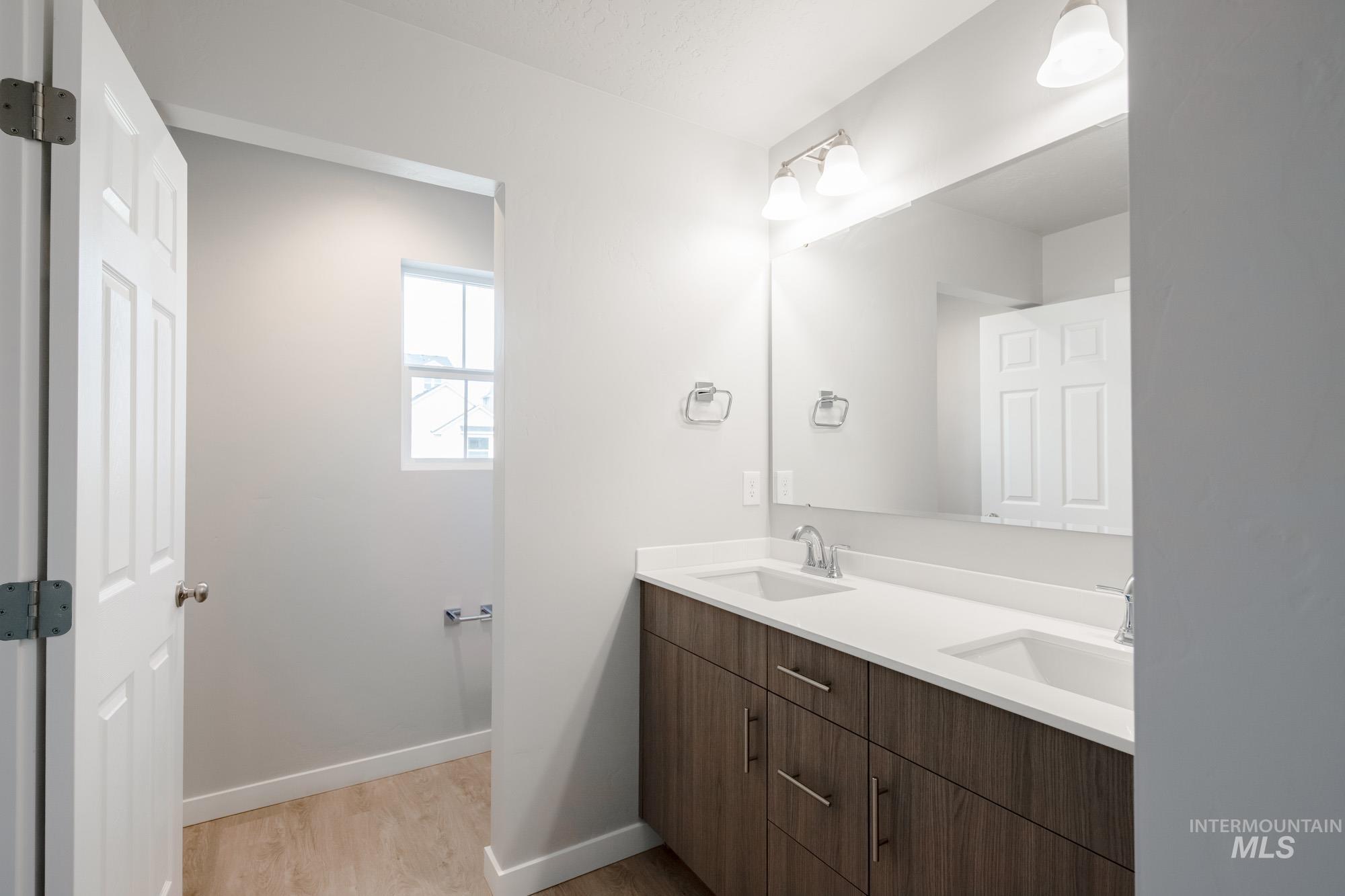 10784 Rutland Street Caldwell, ID 83605 - Photo 18 of 22 Full bathroom with double vanity and light wood-style flooring