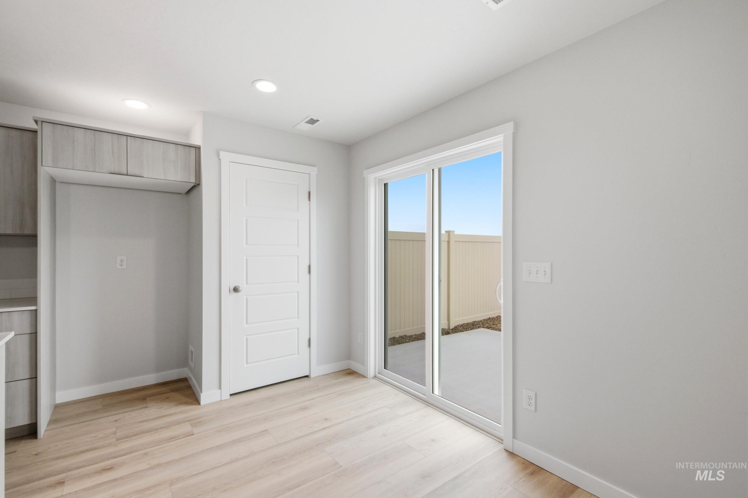 10784 Rutland Street Caldwell, ID 83605 - Photo 7 of 21 Unfurnished bedroom featuring access to outside, light wood-style flooring, and recessed lighting