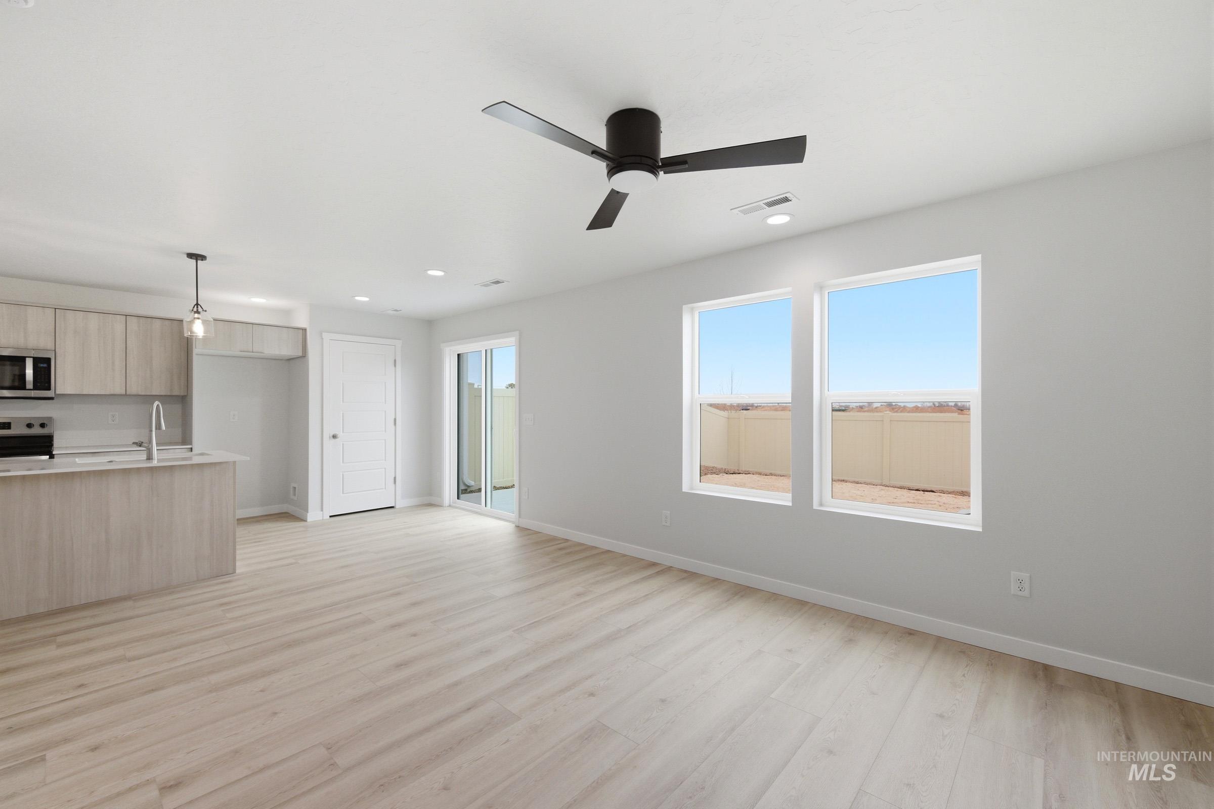 10784 Rutland Street Caldwell, ID 83605 - Photo 8 of 21 Unfurnished living room featuring recessed lighting, light wood-style flooring, plenty of natural light, and ceiling fan