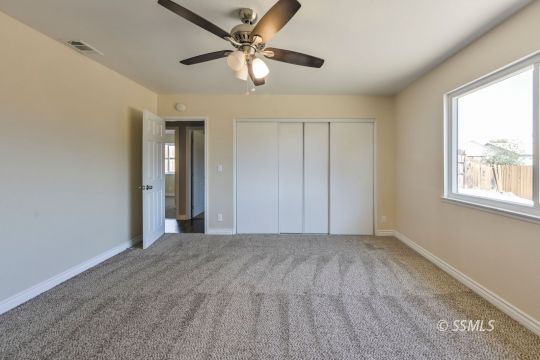 240 West Benson Avenue Ridgecrest, CA 93555 - Photo 22 of 29 a view of a big room with windows and chandelier fan