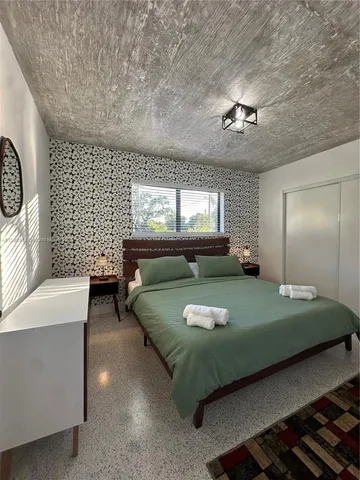 a bedroom with a bed couch and window