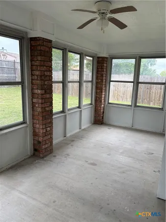a view of backyard with wooden fence