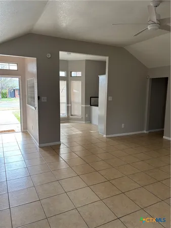 a view of an empty room and wooden floor
