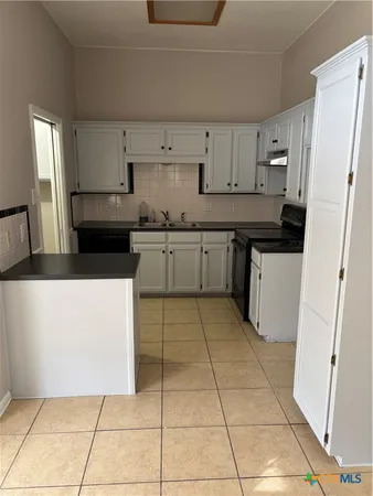 a view of kitchen with furniture and window