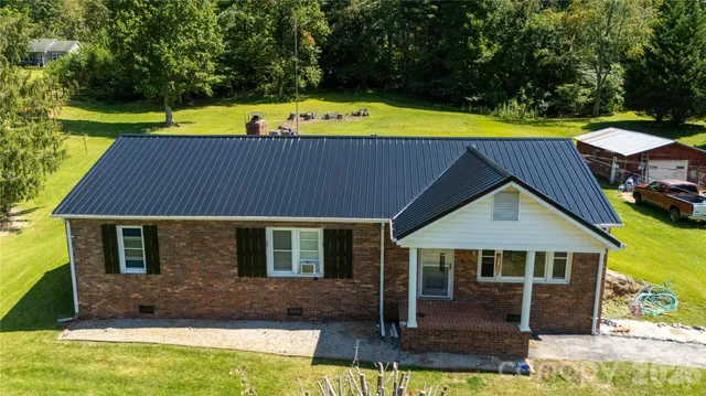 a view of a house with a swimming pool and sitting area
