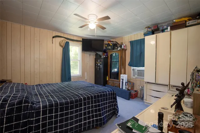 a bed room with a bed and a mirror