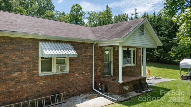 a view of a house with backyard porch and sitting area