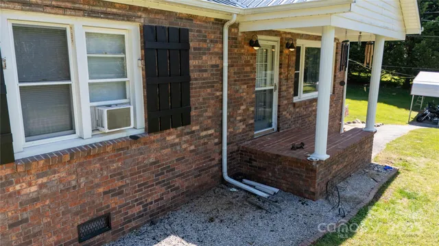 a view of a house with backyard sitting area and garden