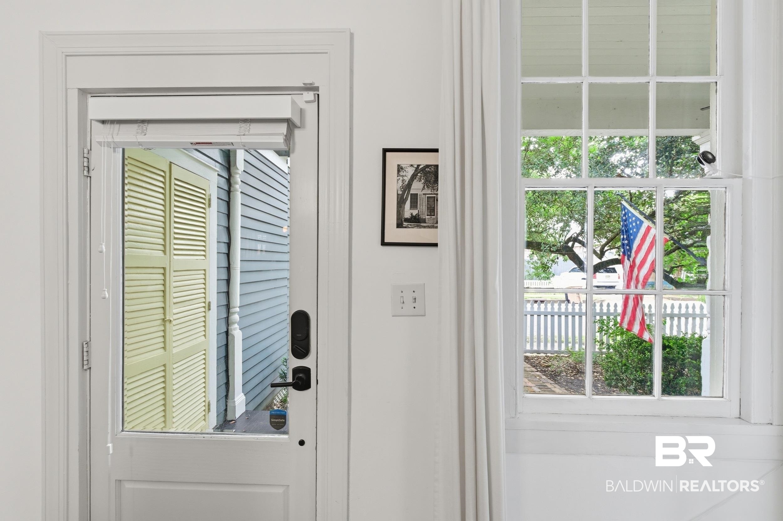 350 Charles Street Mobile, AL 36604 - Photo 29 of 52 Entry door with glass paneling, interior white trim, and matte black hardware