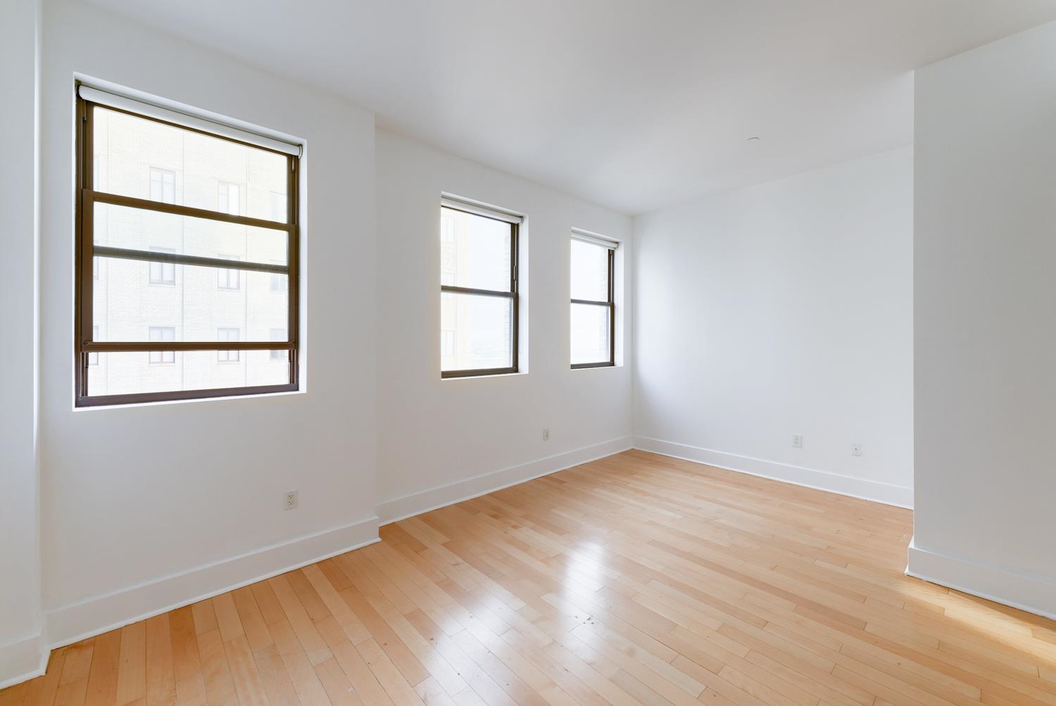 4 Beacon Way, Unit 1511 Jersey City, NJ 07304 - Photo 2 of 17 an empty room with windows
