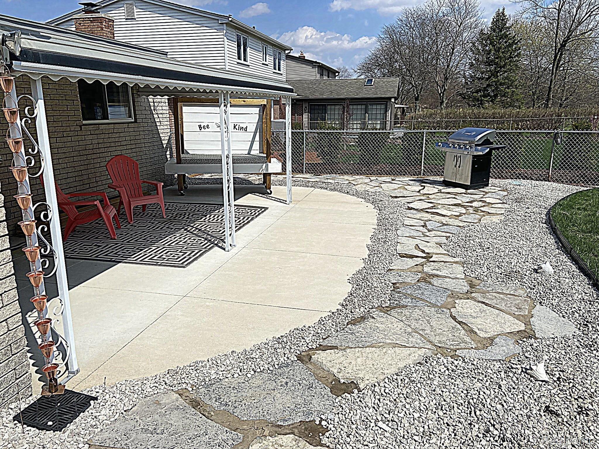 43973 Brandywyne Road Canton, MI 48187 - Photo 29 of 40 South exposure patio, custom paving stones, decorative rain chain