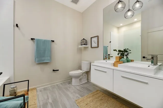 a bathroom with a sink toilet and mirror