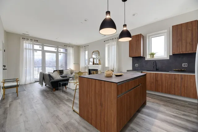 a kitchen with a stove cabinets and wooden floor