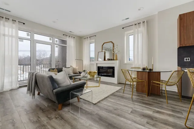 a living room with furniture fireplace and a table