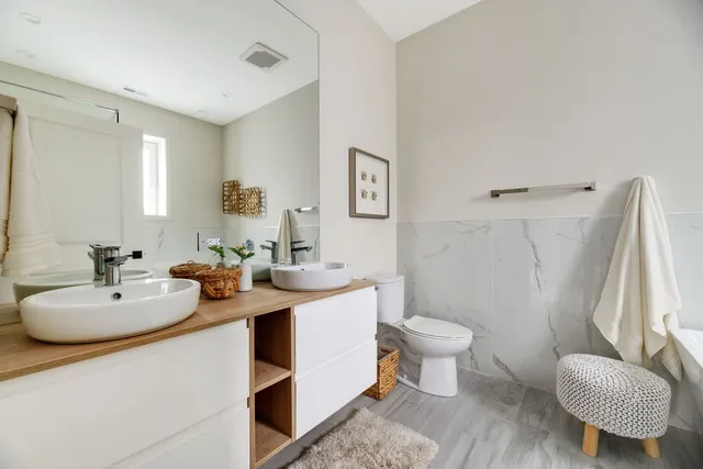 a bathroom with a sink toilet and a mirror