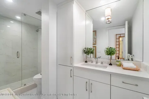a bathroom with a toilet a sink and glass door