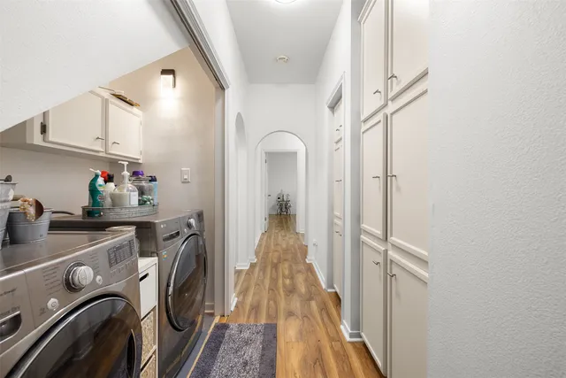 a view of a hallway with a washer and dryer