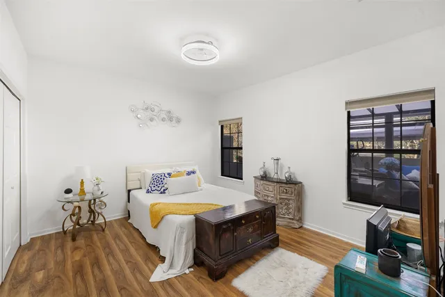 a bed room with a bed window and a table