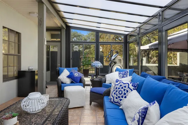 a living room with furniture and a floor to ceiling window