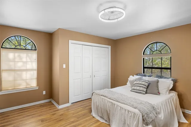 a bedroom with a bed and a window