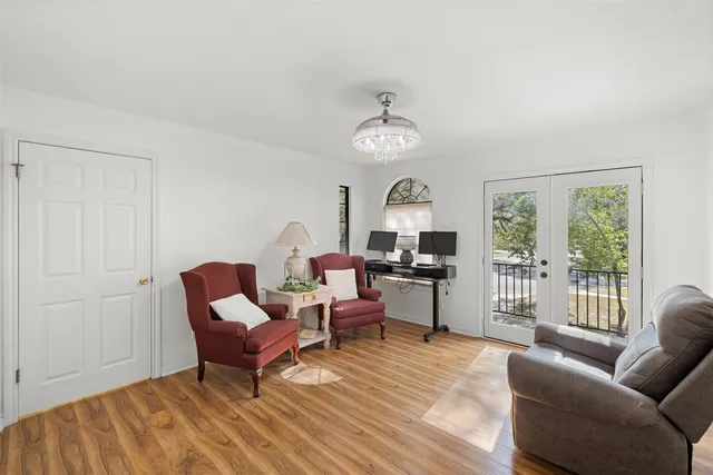 a living room with furniture wooden floor and a window