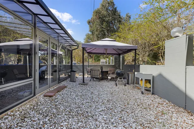 a view of a chairs and table under an umbrella in patio