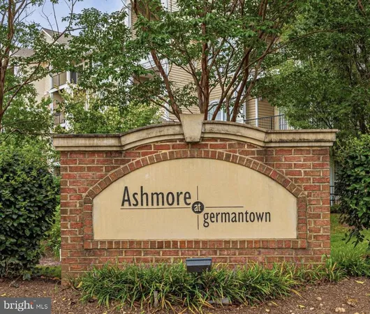 a front view of a residential apartment building with a yard
